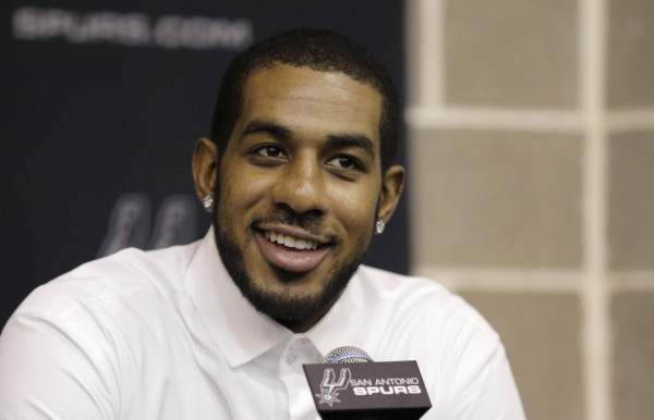 LaMarcus Aldridge answers questions during a news conference at the team's practice facility as he is formally introduced after he signed with the San Antonio Spurs NBA basketball team, Friday, July 10, 2015, in San Antonio. (AP Photo/Eric Gay)